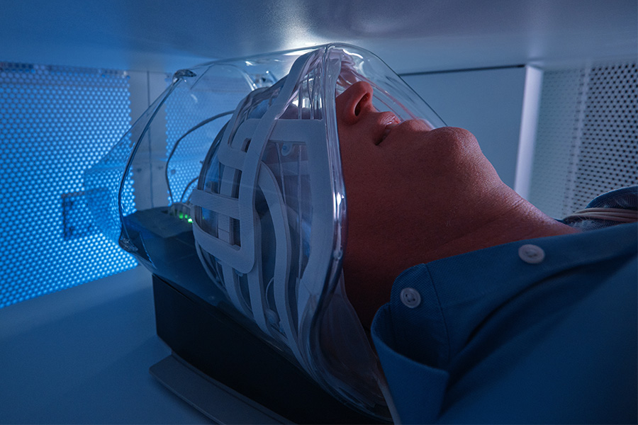 An emergency department patient with their head in the Swoop® AI-powered portable MR imaging system head coil.